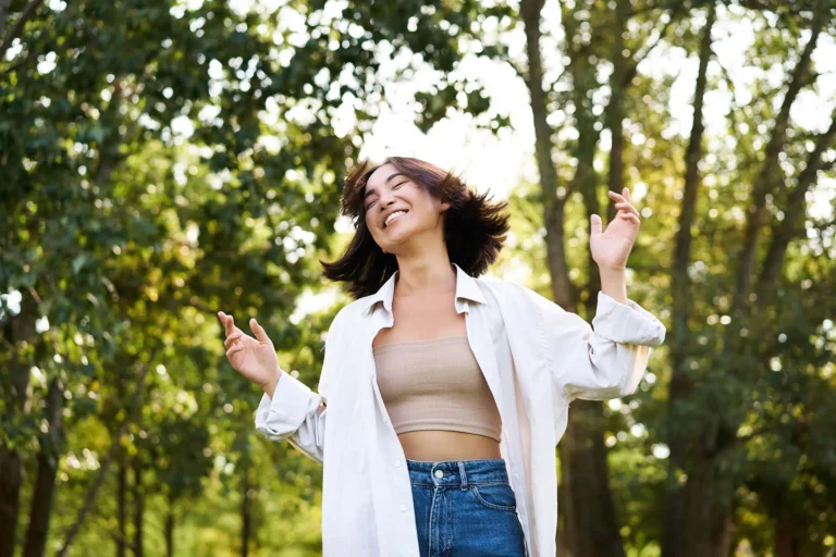 Happy carefree asian girl dancing