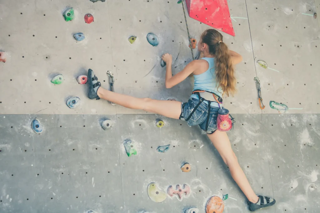 teenager climbing a rock wall recovery activities